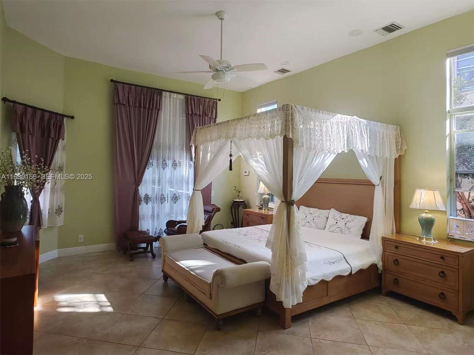 1035 Waterside Circle Weston, FL 33327 - Photo 10 of 40 a bedroom with bed and a chandelier