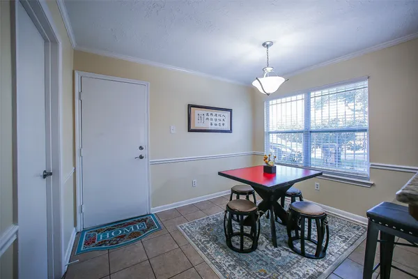 a dining room with furniture and window