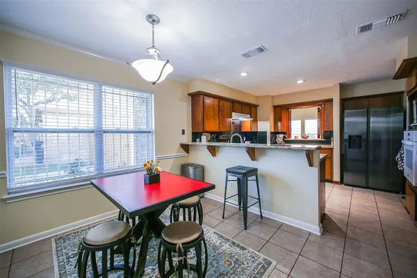 a dining room with furniture and window