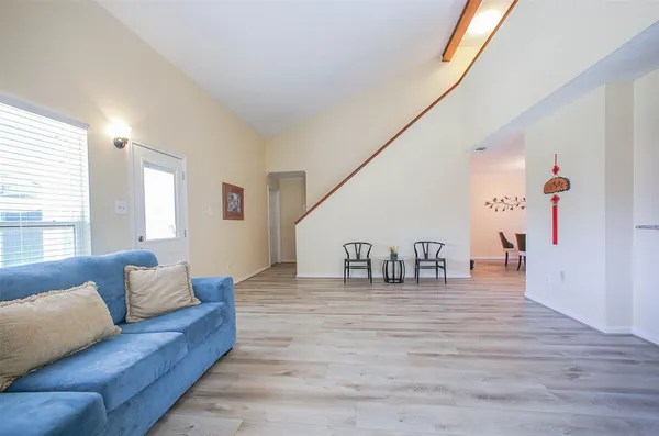 a living room with furniture and stairs