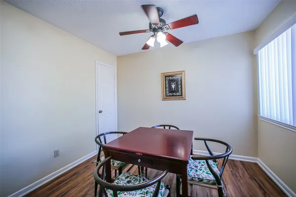 a view of a dining room with furniture and wooden floor