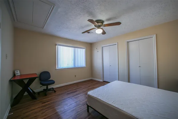 a workspace room with wooden floor and windows