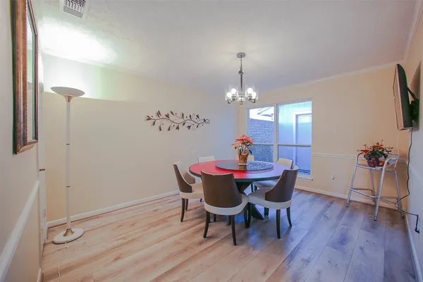a view of a dining room with furniture and wooden floor