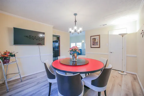 a dining room with furniture and wooden floor