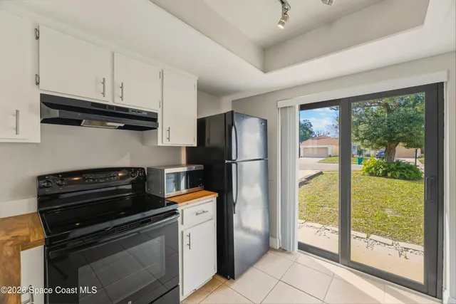 a kitchen with a stove a refrigerator and a stove top oven