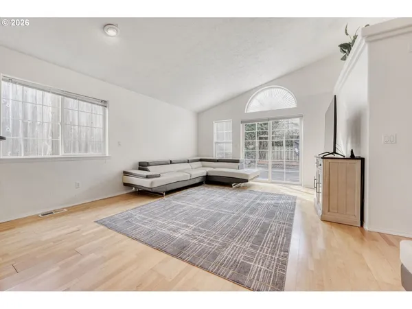 a living room with furniture window and wooden floor