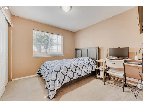 a bedroom with a bed and flat screen tv