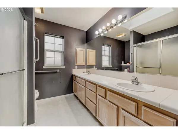 a spacious bathroom with a double vanity sink and a mirror