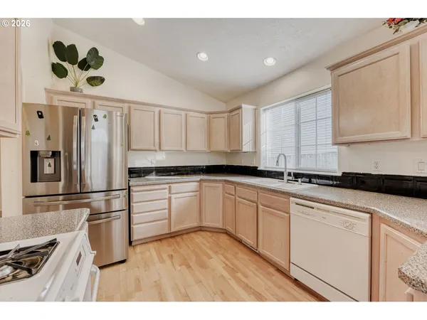 a kitchen with a refrigerator and a sink
