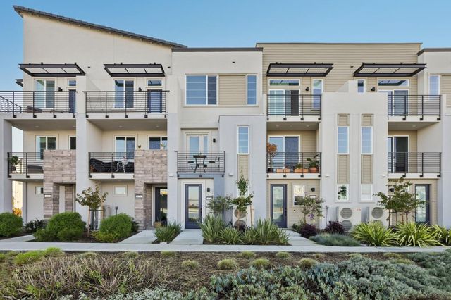 a front view of a residential apartment building with a yard
