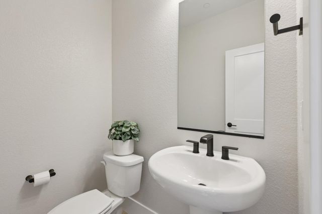 a bathroom with a sink mirror and toilet