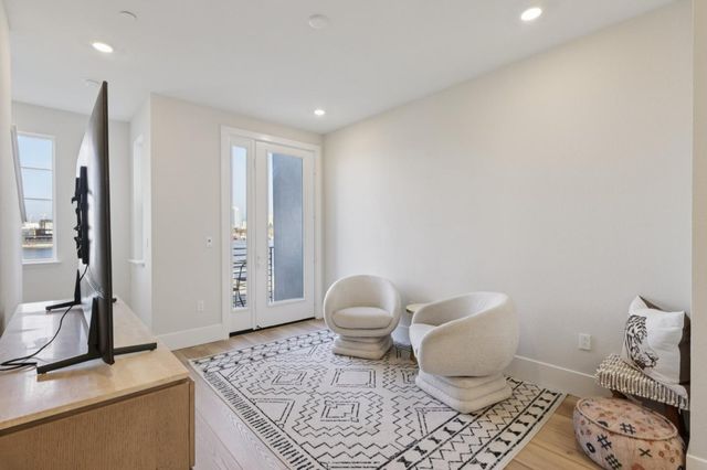 a bathroom with a granite countertop toilet and a sink