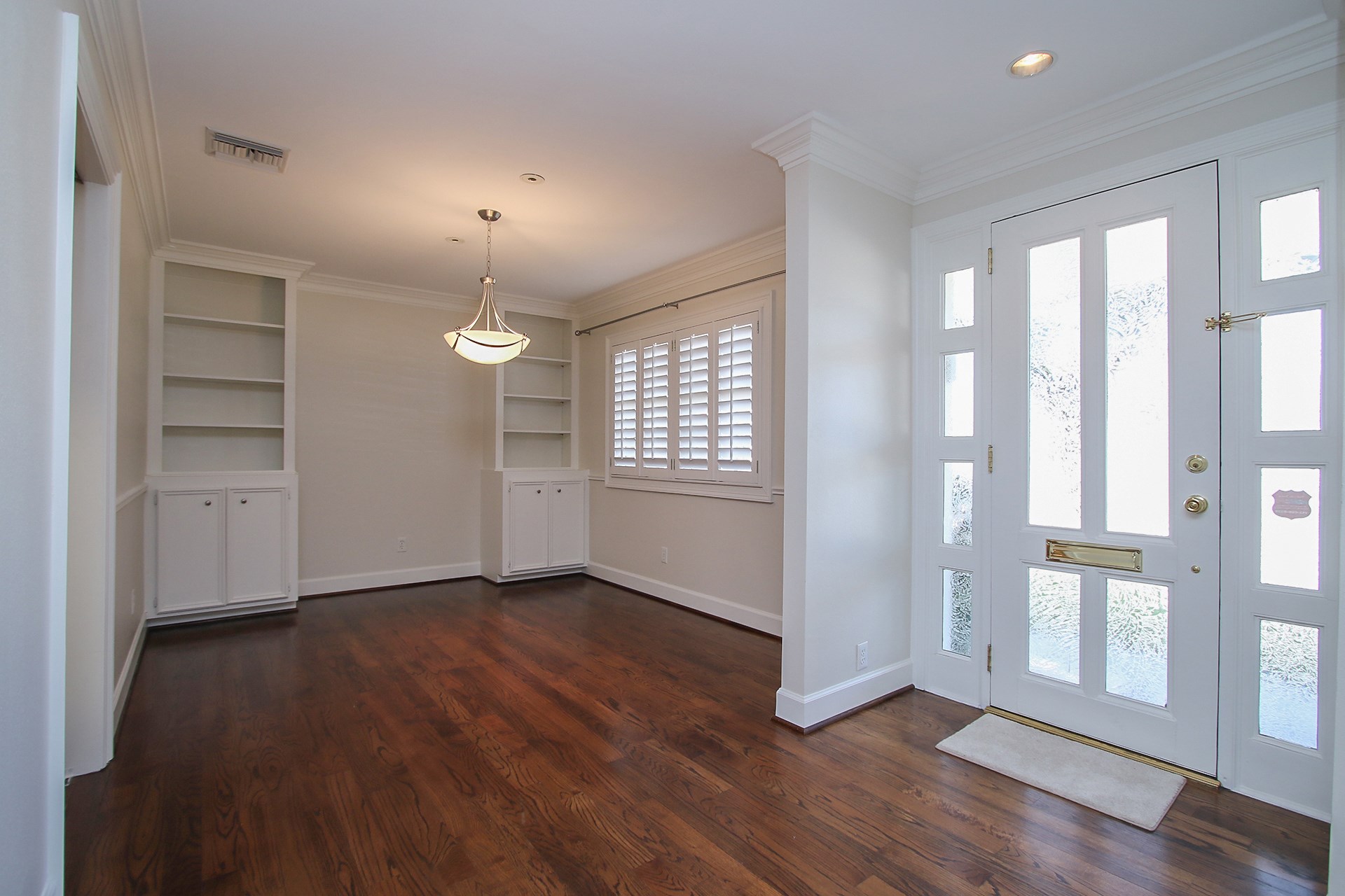 6208 Kirby Drive Houston, TX 77005 - Photo 3 of 19 a view of an empty room with a window and wooden floor