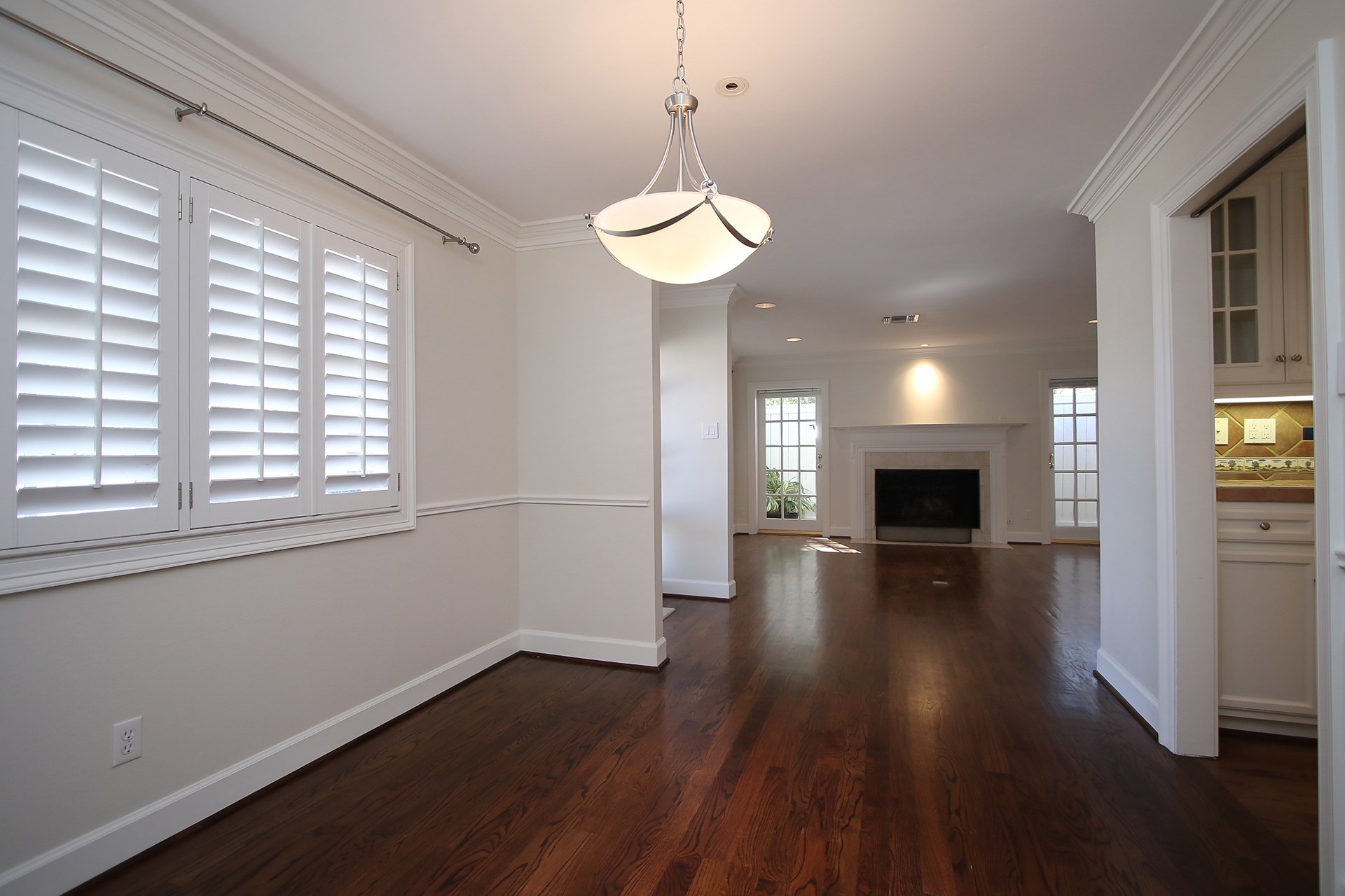 6208 Kirby Drive Houston, TX 77005 - Photo 4 of 19 a view of empty room with wooden floor and fireplace