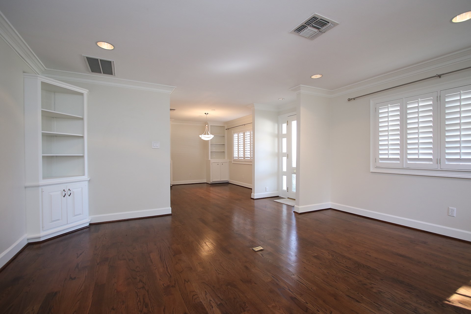 6208 Kirby Drive Houston, TX 77005 - Photo 5 of 19 a view of an empty room with wooden floor and a window