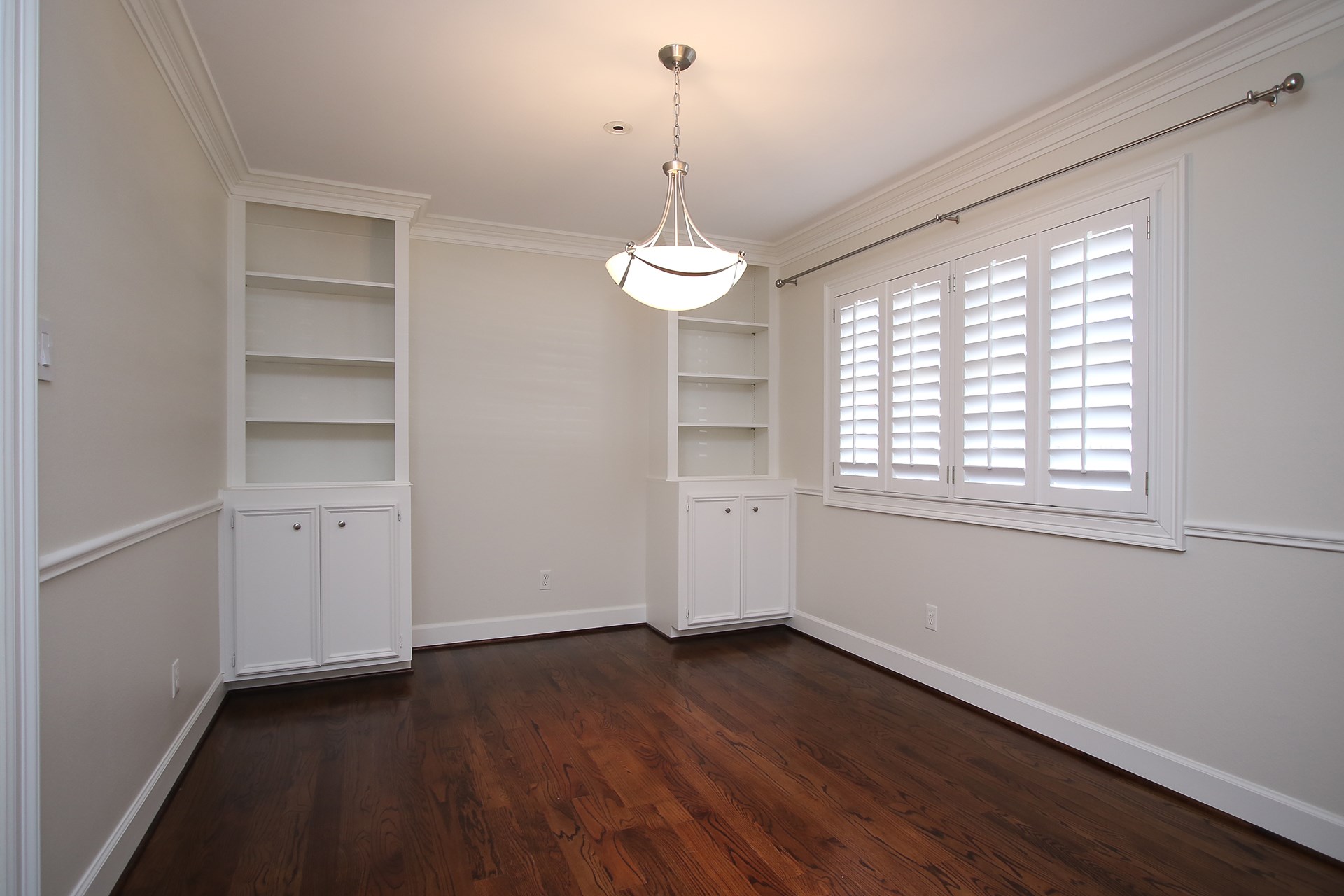 6208 Kirby Drive Houston, TX 77005 - Photo 7 of 19 a view of a room with wooden floor and windows