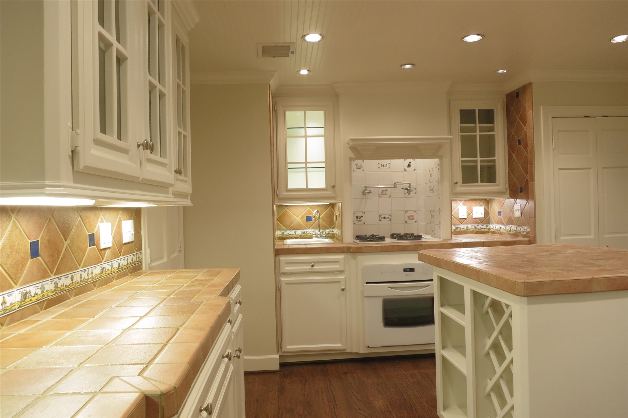 6208 Kirby Drive Houston, TX 77005 - Photo 8 of 19 a kitchen with a stove and white cabinets