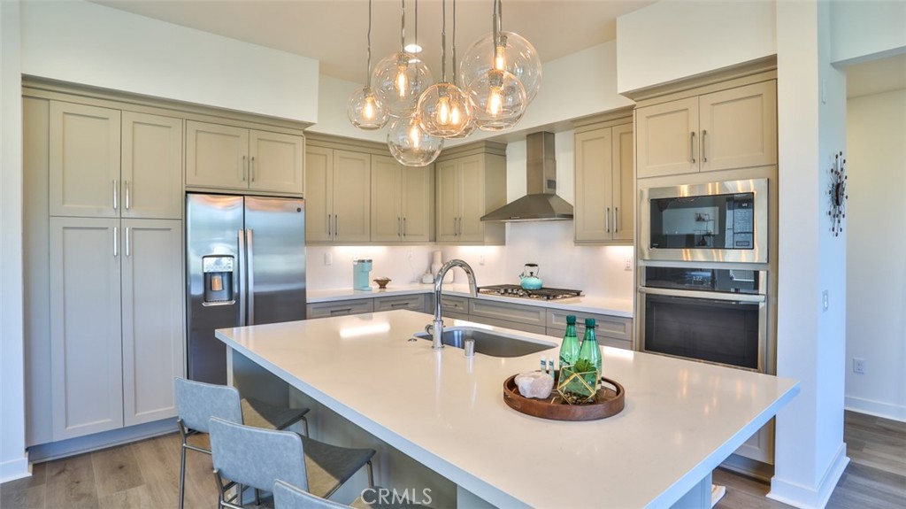 1207 Doheny Way Dana Point, CA 92629 - Photo 69 of 74 a kitchen with kitchen island a table and chairs in it