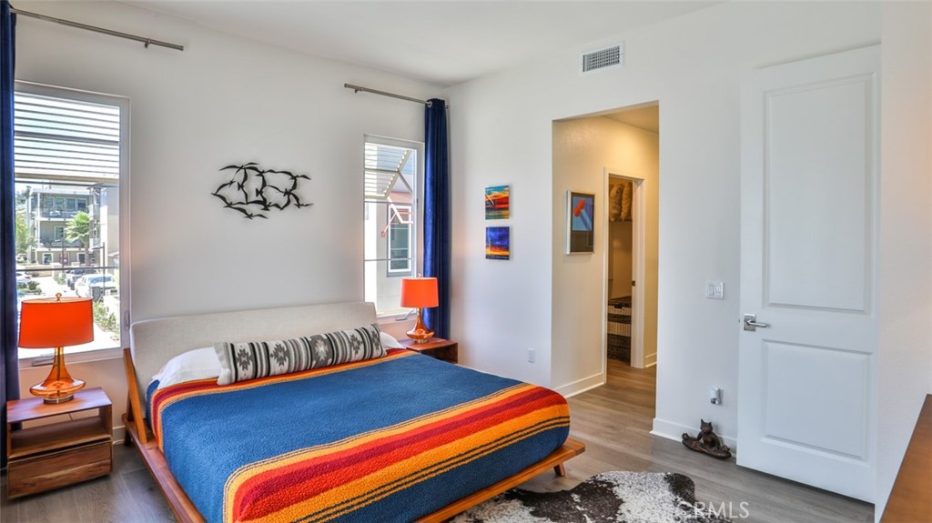 1207 Doheny Way Dana Point, CA 92629 - Photo 12 of 74 a bedroom with a bed and wooden floor