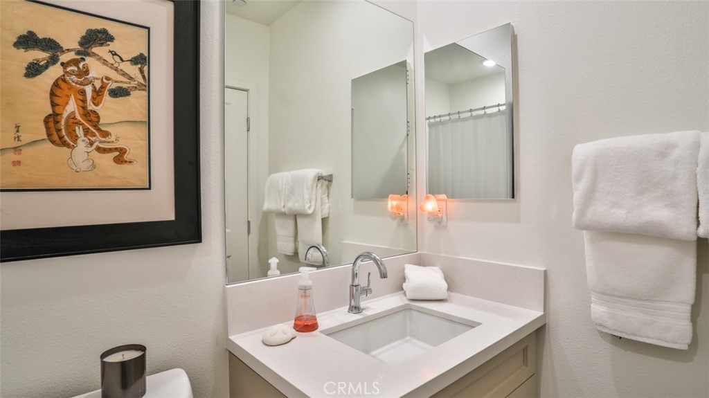 1207 Doheny Way Dana Point, CA 92629 - Photo 22 of 74 a bathroom with a sink and a mirror