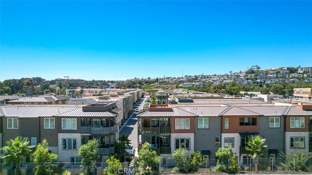 1207 Doheny Way Dana Point, CA 92629 - Photo 38 of 74 a front view of a residential apartment building with a yard