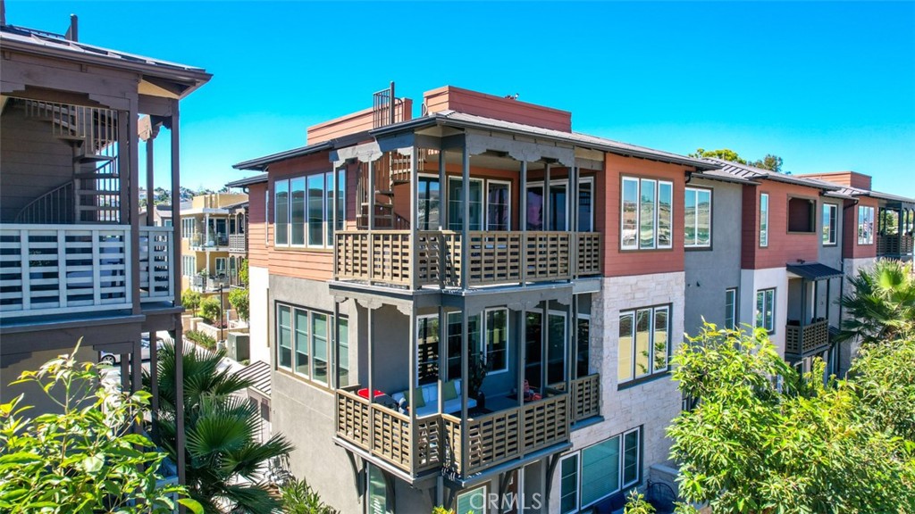 1207 Doheny Way Dana Point, CA 92629 - Photo 46 of 74 a front view of a residential apartment building with a yard