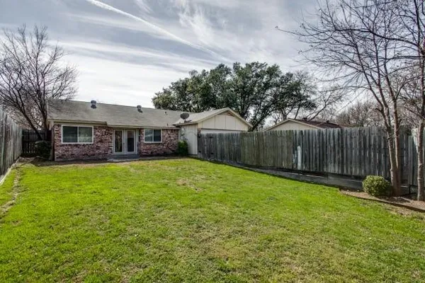 a front view of a house with yard and green space