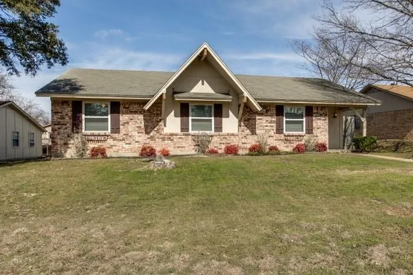 a front view of house with yard and green space
