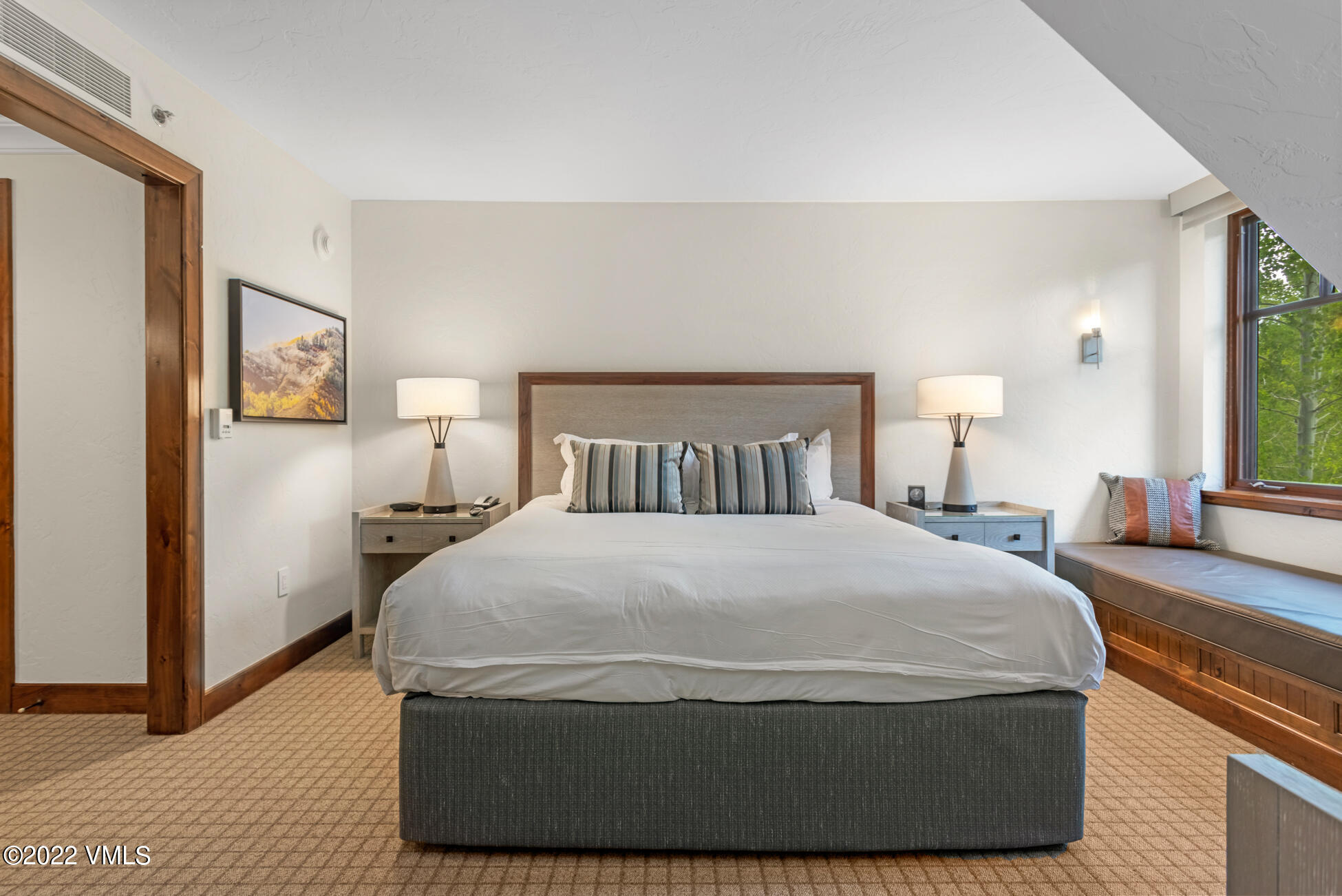 100 Bachelor Ridge Road, Unit 3404 Avon, CO 81620 - Photo 13 of 46 a large bed sitting in a bedroom next to a window