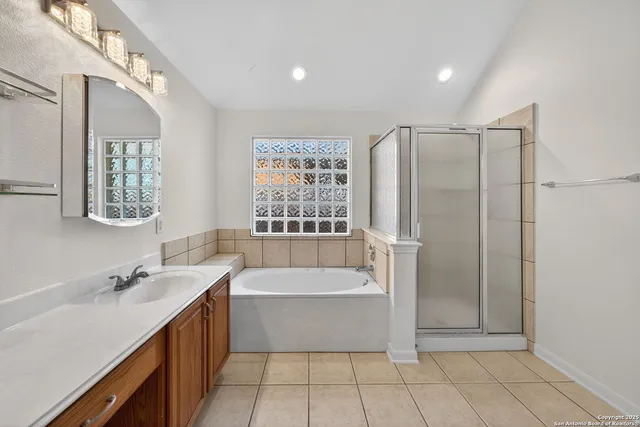 a bathroom with a tub a sink and a shower