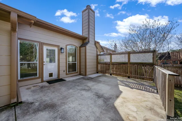 a view of a backyard with iron fence