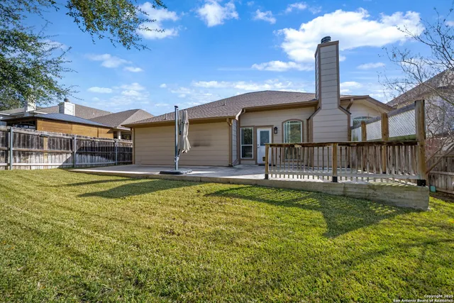 a view of a house with swimming pool next to a yard