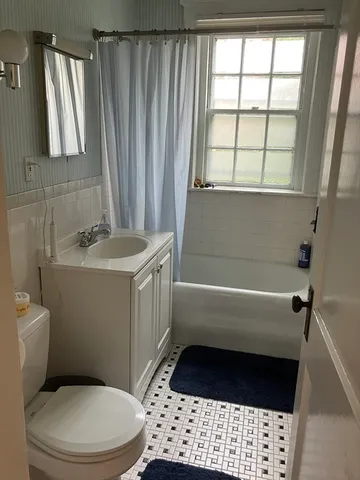 a bedroom with a bed and a view of bathroom