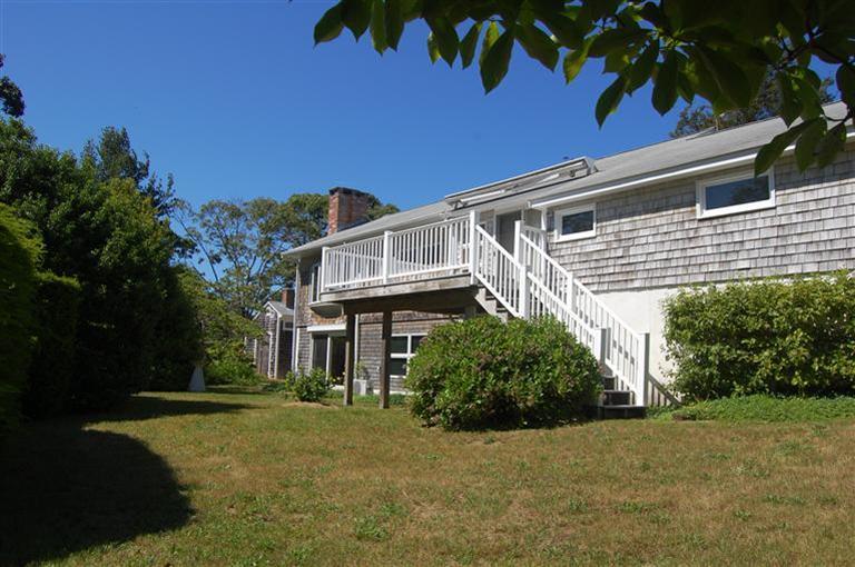 10 Nickerson Road Eastham, MA 02642 - Photo 1 of 24 a front view of a house with a yard and garage