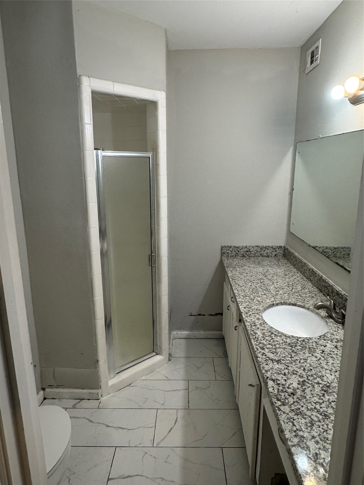 2522 Jackson La Marque, TX 77568 - Photo 11 of 18 a bathroom with a granite countertop sink and a mirror