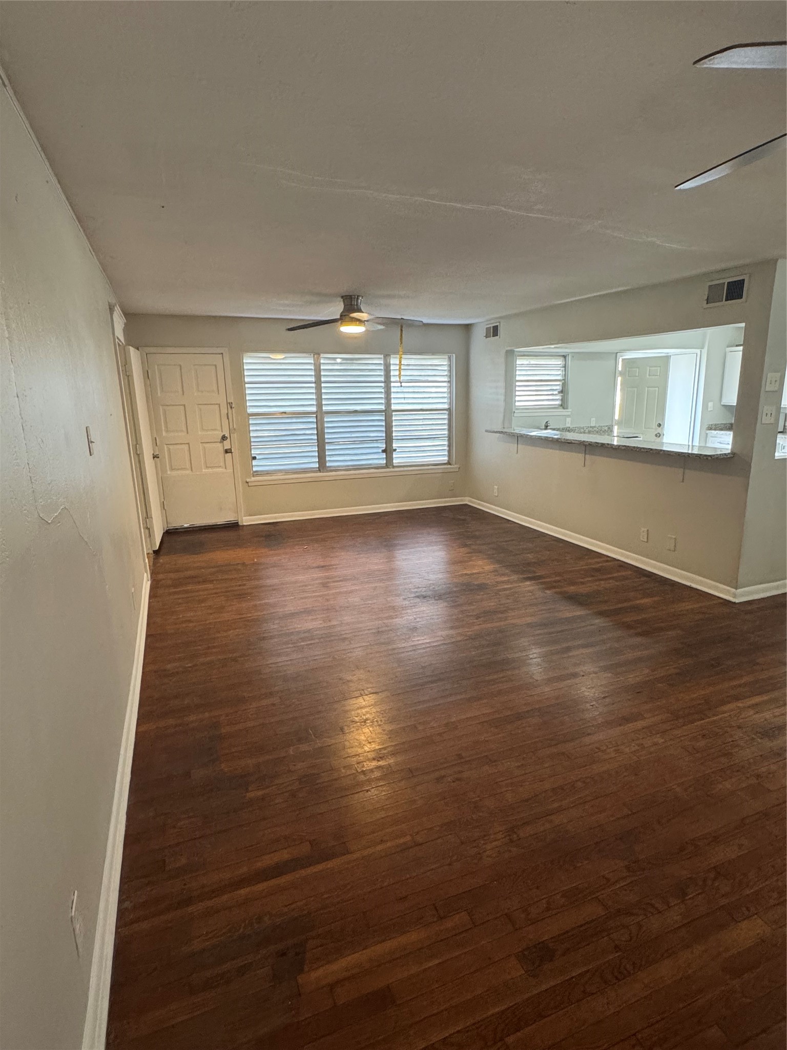 2522 Jackson La Marque, TX 77568 - Photo 3 of 18 an empty room with wooden floor and windows