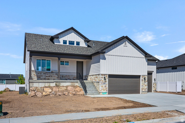 1144 South 4475 West West Point, UT 84015 - Photo 2 of 30 Modern two-story residence featuring light siding, stone accents, and a dark shingle roof