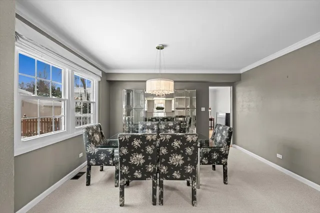 a view of a dining room with furniture and window