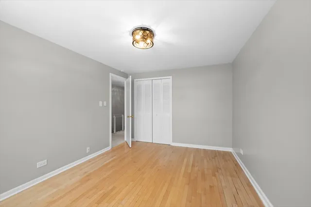 a view of a room with wooden floor and window