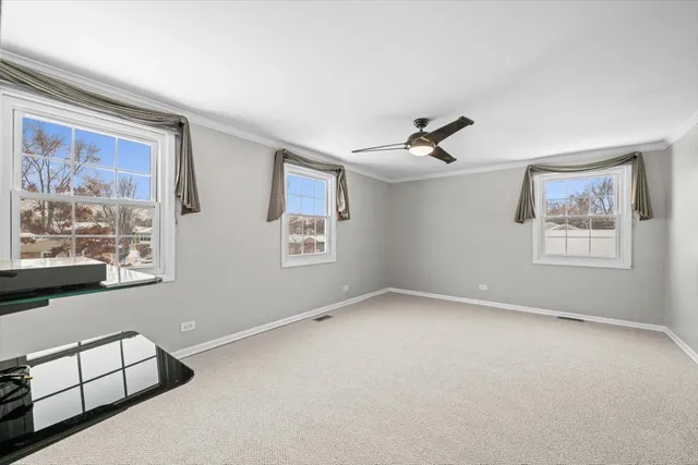 an empty room with windows and couch