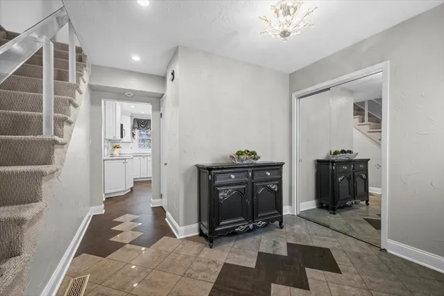 a view of a hallway to a livingroom with furniture and staircase