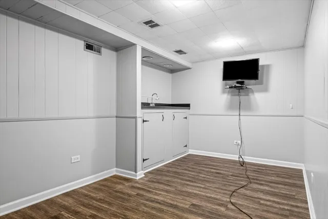 a view of a kitchen with wooden floor and a sink