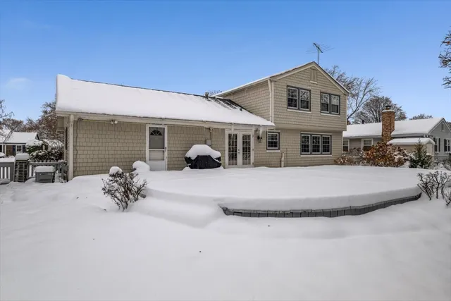 a view of a house with a yard and sitting area
