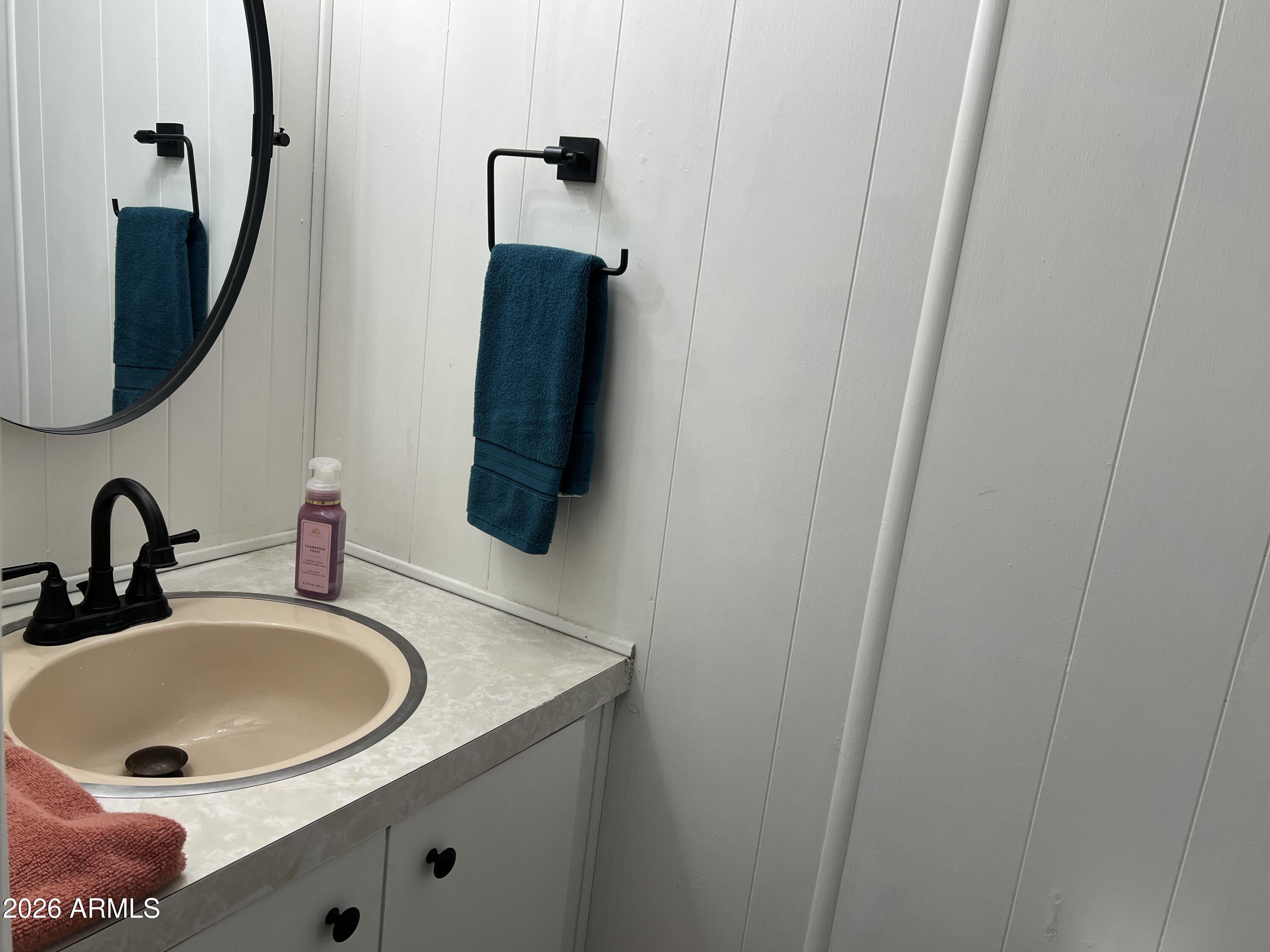 19225 North Cave Creek Road, Unit 40 Phoenix, AZ 85024 - Photo 7 of 21 a bathroom with a sink and a mirror