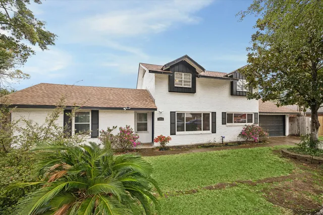 a view of empty room with wooden floor and fireplace