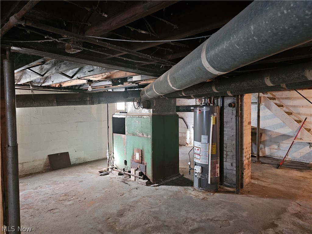 633 Riley Avenue East Liverpool, OH 43920 - Photo 16 of 21 Unfinished basement featuring water heater and heating unit