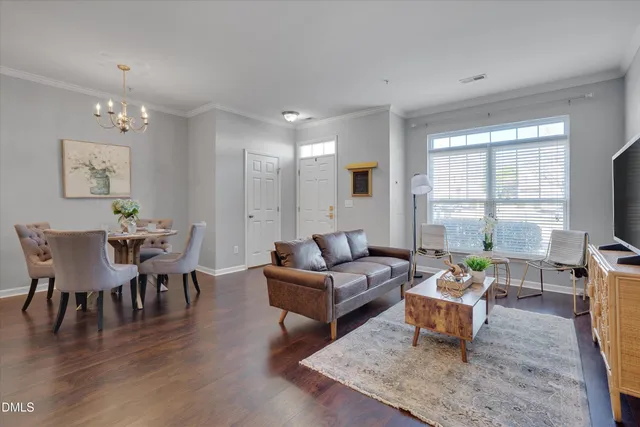 a living room with furniture a wooden floor and a window