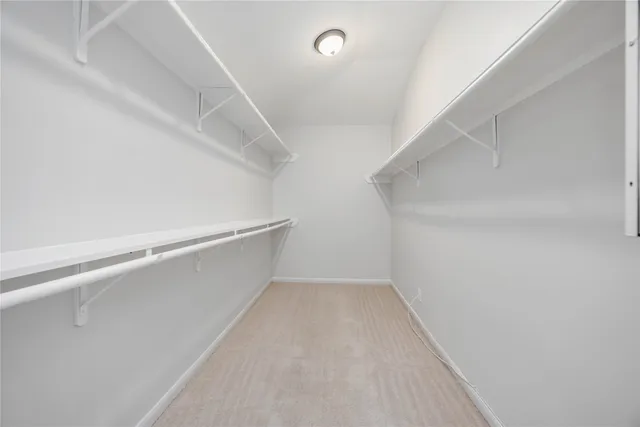 a spacious bathroom with a granite countertop sink and a mirror
