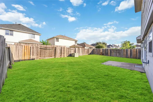 a view of a house with a backyard