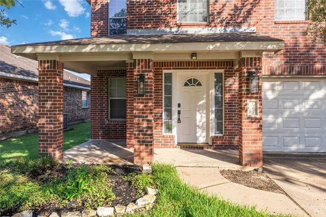 a view of a house with a small backyard